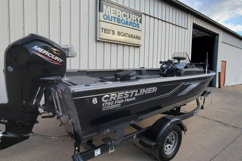 Slide: The Image of 2022 Crestliner 1750 Fish Hawk WT boat on trailer outside Mercury Outboards shop. - 15