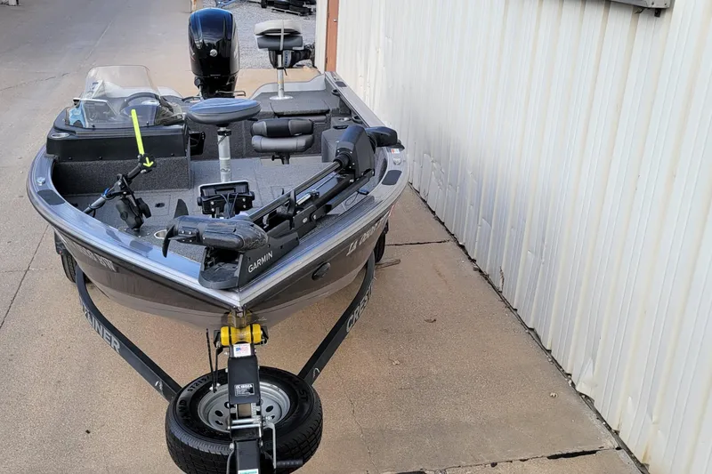 Slide: The Image of 2022 Crestliner 1750 Fish Hawk WT boat parked beside a building. - 3