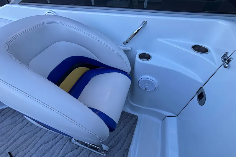 Slide: The Image of 2008 Baja 277 Islander boat interior with white and blue seating, cup holders, and speaker. - 11