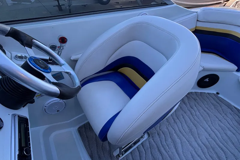 Slide: The Image of Interior of 2008 Baja 277 Islander boat with steering wheel and cushioned seat. - 12
