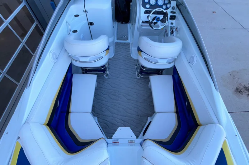 Slide: The Image of 2008 Baja 277 Islander boat interior with white seating and modern dashboard. - 19