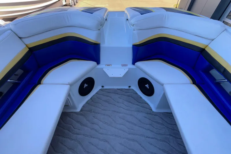 Slide: The Image of 2008 Baja 277 Islander boat interior with blue, white, and yellow seating. - 24