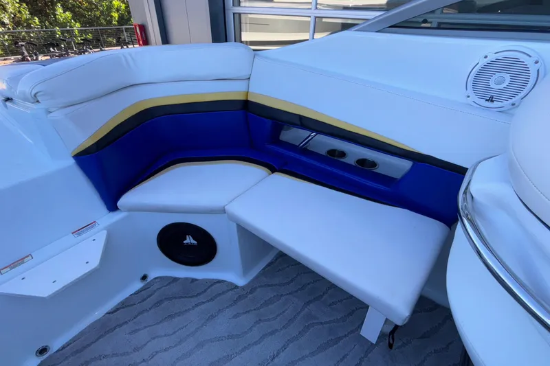 Slide: The Image of 2008 Baja 277 Islander boat interior with white, blue, and yellow seating and built-in speakers. - 25