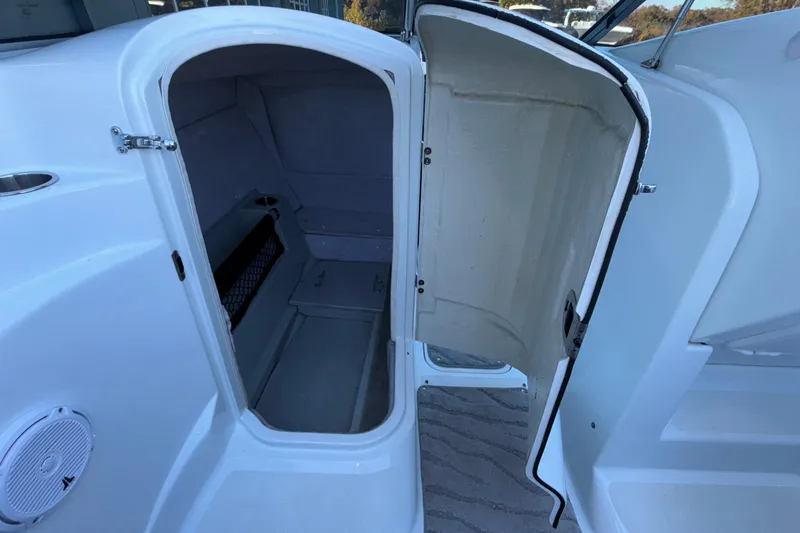 Slide: The Image of 2008 Baja 277 Islander boat cabin interior with open door, showcasing storage space. - 28