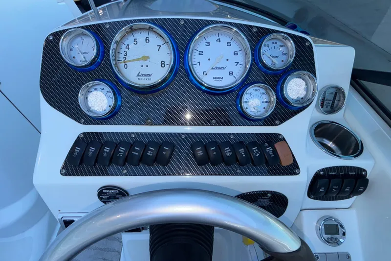 Slide: The Image of Dashboard of a 2008 Baja 277 Islander boat with gauges and controls. - 33