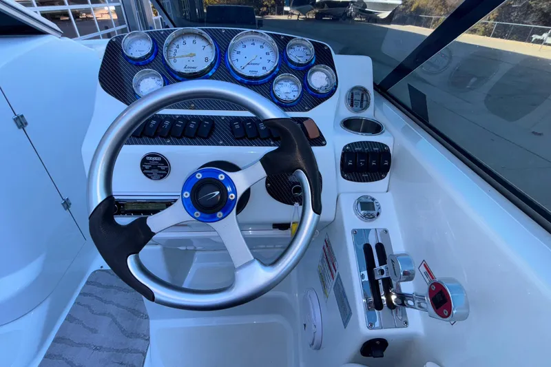 Slide: The Image of Steering console of a 2008 Baja 277 Islander boat with gauges and controls. - 34
