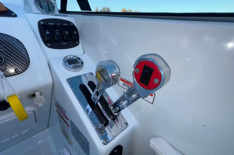 Slide: The Image of 2008 Baja 277 Islander boat controls with throttle levers and dashboard instruments. - 35