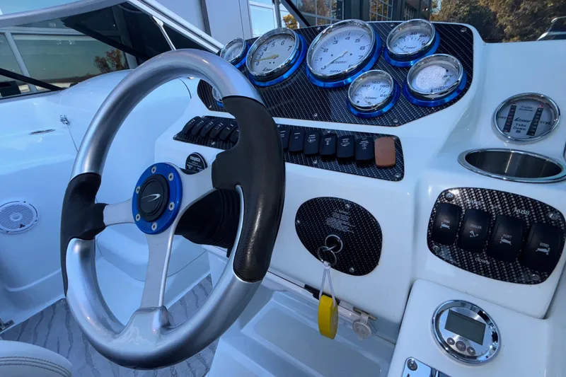 Slide: The Image of Steering wheel and dashboard of 2008 Baja 277 Islander boat with gauges and controls. - 36