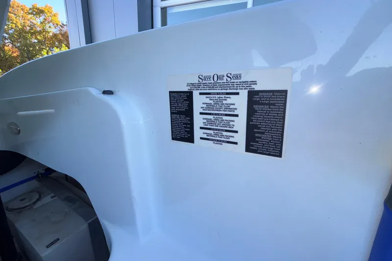 Slide: The Image of 2008 Baja 277 Islander boat with environmental warning label, emphasizing ocean conservation. - 40