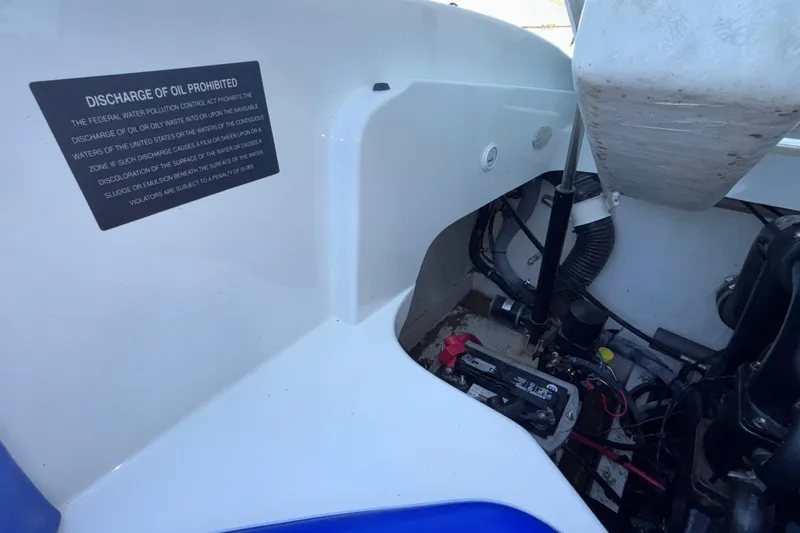 Slide: The Image of Engine compartment of a 2008 Baja 277 Islander boat with oil discharge warning sign. - 41