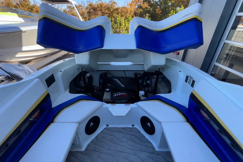 Slide: The Image of 2008 Baja 277 Islander boat interior with blue and yellow seating and engine compartment. - 46