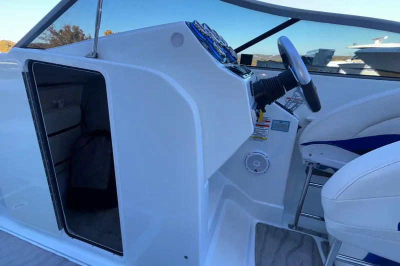 Slide: The Image of 2008 Baja 277 Islander boat cockpit with steering wheel and seating area. - 47