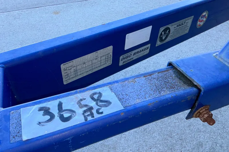 Slide: The Image of Blue trailer frame with labels and rusted bolt, Baja 277 Islander 2008. - 6