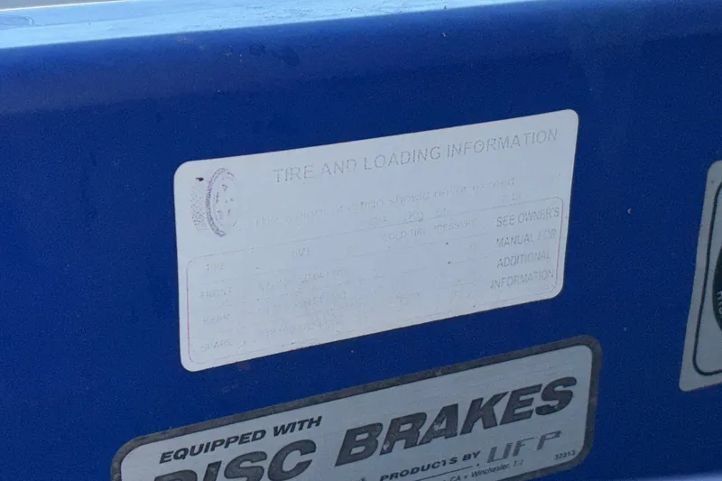 Slide: The Image of 2008 Baja 277 Islander tire and loading information label on blue surface. - 7