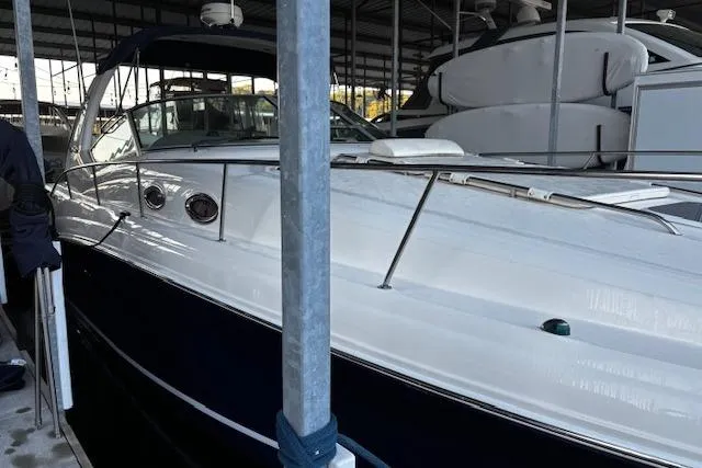 Slide: The Image of 2005 Sea Ray 340 Sundancer docked in a marina, showcasing sleek design and luxury features. - 11