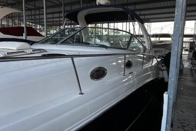 Slide: The Image of 2005 Sea Ray 340 Sundancer yacht docked in a covered marina. - 13