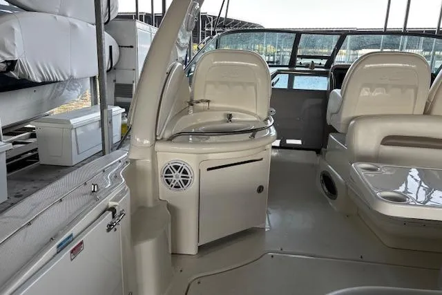 Slide: The Image of 2005 Sea Ray 340 Sundancer interior with seating and helm, docked at marina. - 3