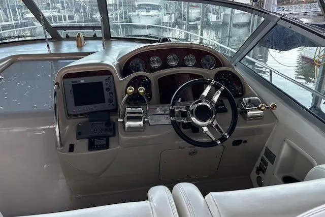 Slide: The Image of 2005 Sea Ray 340 Sundancer helm with modern controls and navigation equipment. - 6