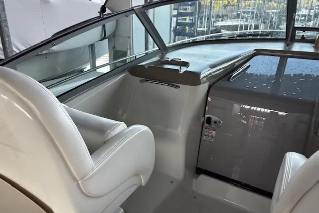 Slide: The Image of 2005 Sea Ray 340 Sundancer cockpit with white seating and dashboard view. - 7