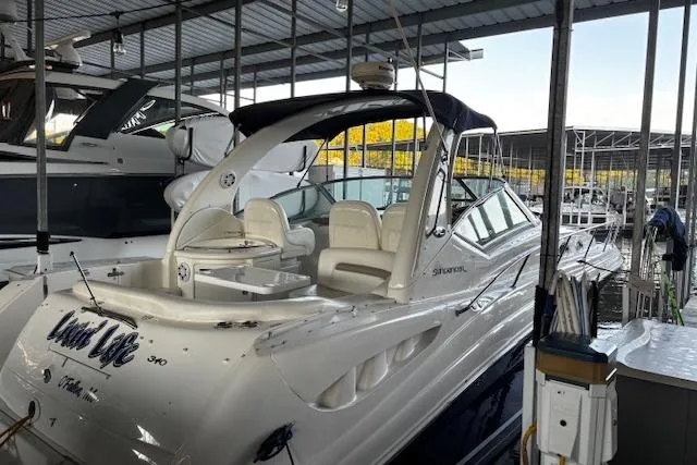 Slide: The Image of 2005 Sea Ray 340 Sundancer yacht docked in a marina, featuring sleek design and spacious seating. - 9