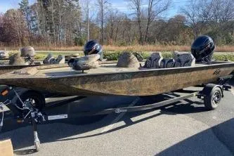 The Image of 2026 G3 Sportsman 1810 PFX boat on trailer, parked outdoors, showcasing sleek design. - 1