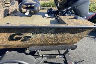 Slide: The Image of 2026 G3 Sportsman 1810 PFX boat with camouflage design on trailer. - 2