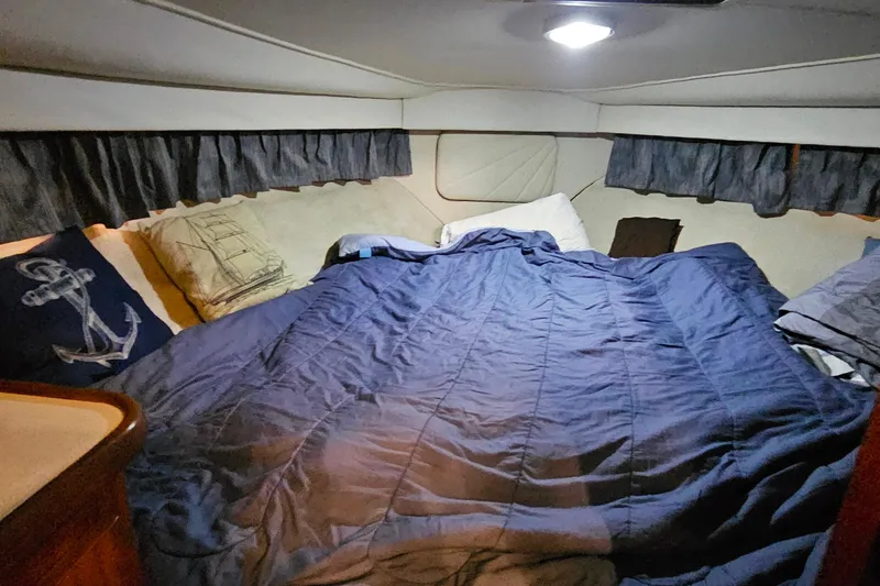 Slide: The Image of Cozy bedroom in 1994 Carver 390 Cockpit Motor Yacht with nautical-themed pillows. - 24