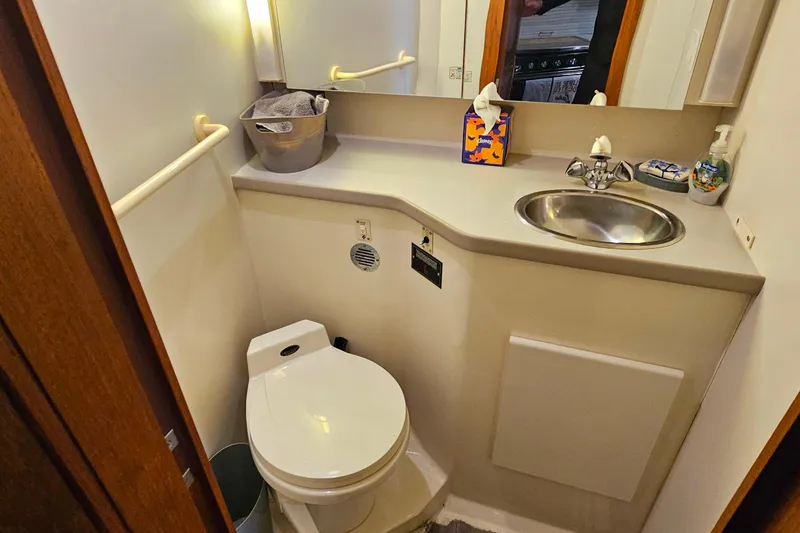 Slide: The Image of Bathroom interior of 1994 Carver 390 Cockpit Motor Yacht with sink and toilet. - 26