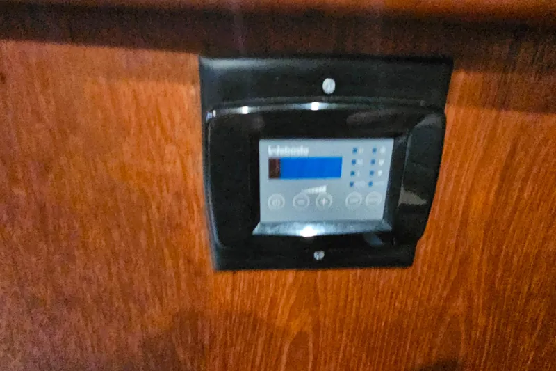 Slide: The Image of Control panel on 1994 Carver 390 Cockpit Motor Yacht, mounted on wooden surface. - 30