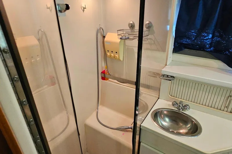 Slide: The Image of Bathroom interior of 1994 Carver 390 Cockpit Motor Yacht with shower and sink. - 35