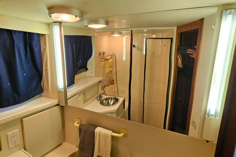 Slide: The Image of Bathroom interior of 1994 Carver 390 Cockpit Motor Yacht with sink and mirror. - 36