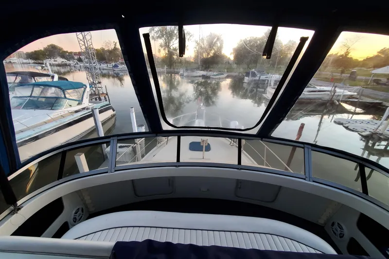 Slide: The Image of 1994 Carver 390 Cockpit Motor Yacht at marina during sunset, view from cockpit. - 9