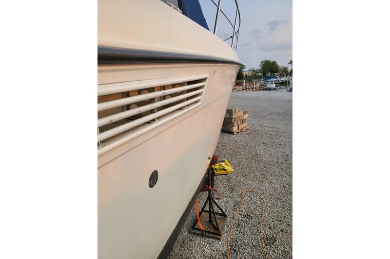 Slide: The Image of 1994 Carver 390 Cockpit Motor Yacht side view on dry dock, gravel ground. - 10