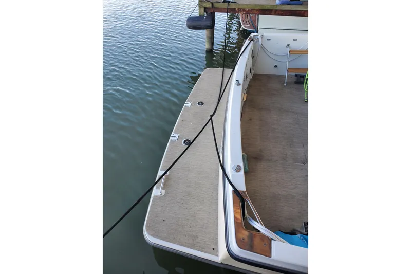 Slide: The Image of 1994 Carver 390 Cockpit Motor Yacht docked, showing rear deck and water. - 14