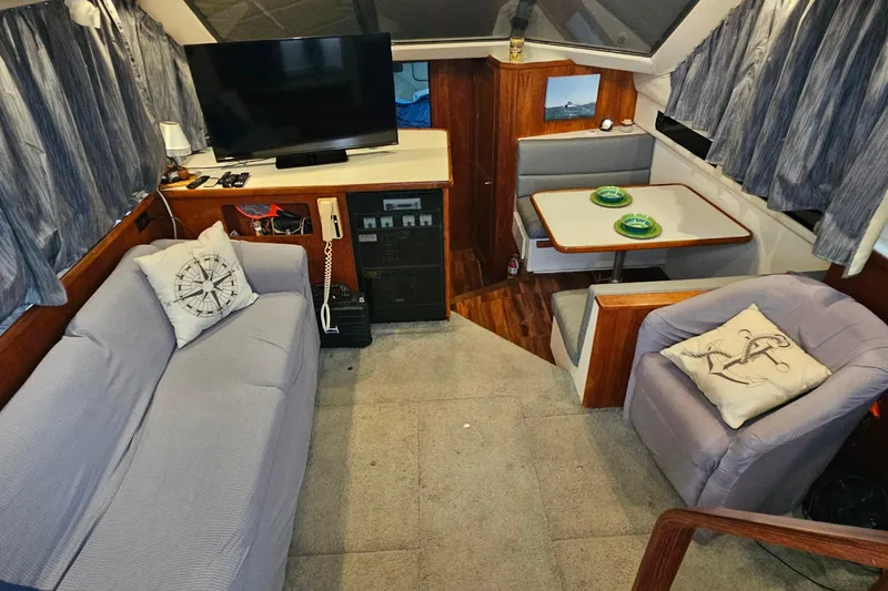 Slide: The Image of Interior of 1994 Carver 390 Cockpit Motor Yacht with cozy seating and dining area. - 15