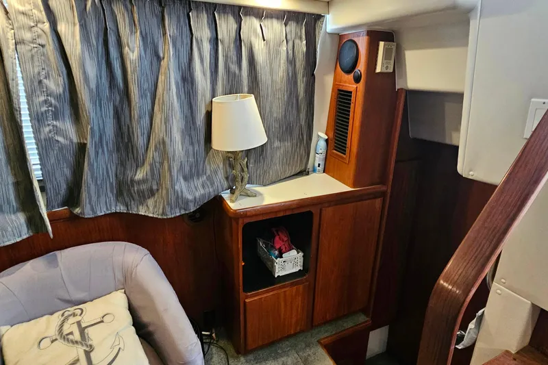 Slide: The Image of Interior of 1994 Carver 390 Cockpit Motor Yacht with wood paneling and nautical decor. - 17
