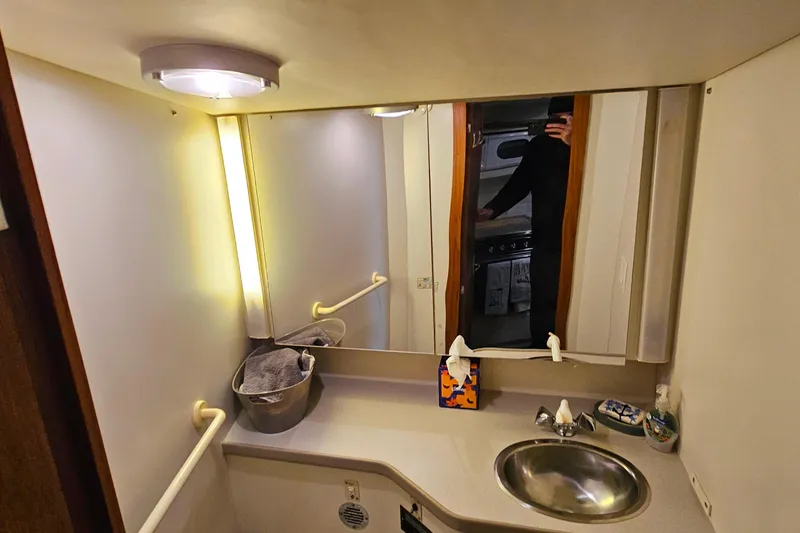 Slide: The Image of Bathroom interior of 1994 Carver 390 Cockpit Motor Yacht with sink and mirror. - 27