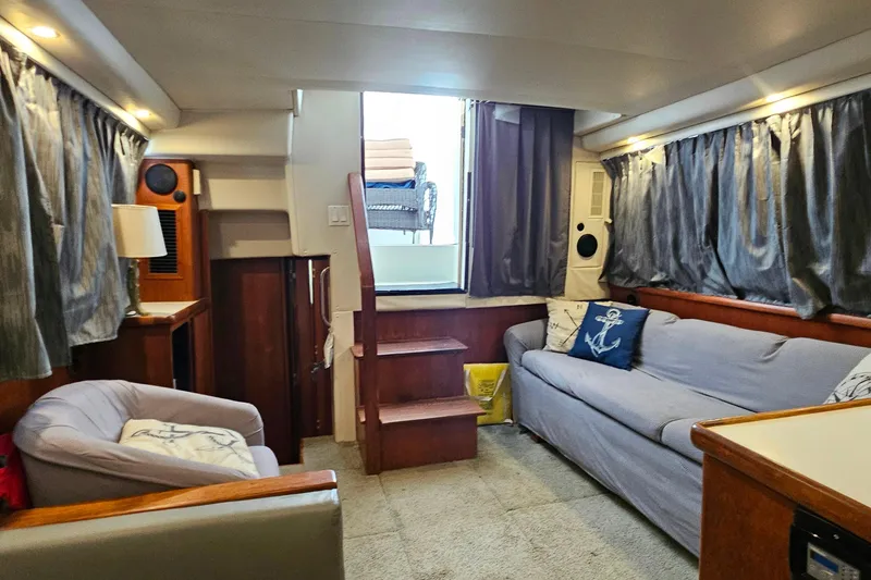 Slide: The Image of Interior of 1994 Carver 390 Cockpit Motor Yacht with cozy seating and nautical decor. - 29
