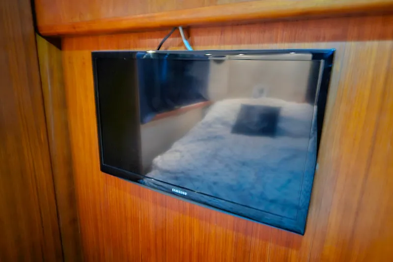 Slide: The Image of Flat-screen TV mounted on wood paneling inside 1994 Carver 390 Cockpit Motor Yacht. - 33
