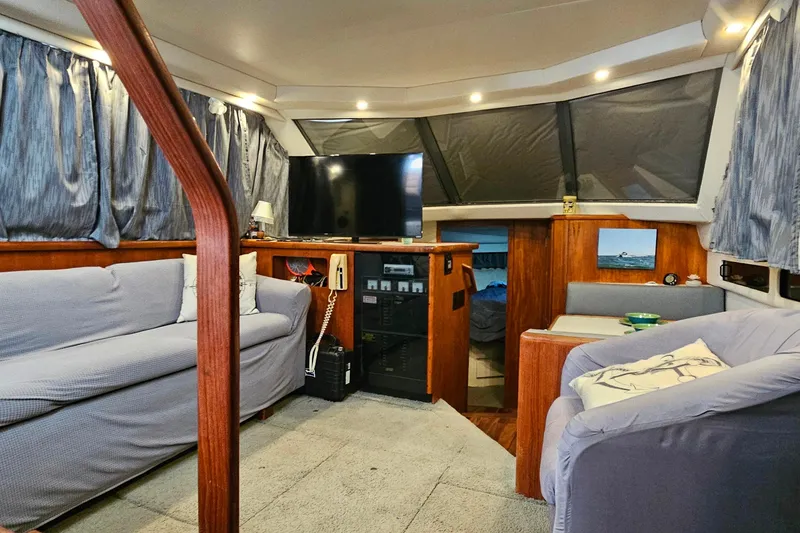 Slide: The Image of Interior of 1994 Carver 390 Cockpit Motor Yacht with cozy seating and modern amenities. - 40