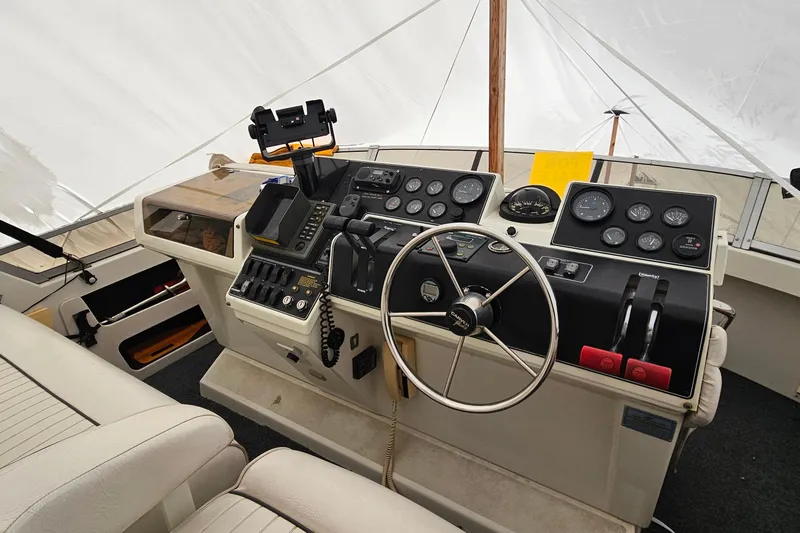 Slide: The Image of 1994 Carver 390 Cockpit Motor Yacht helm with steering wheel and control panel. - 41