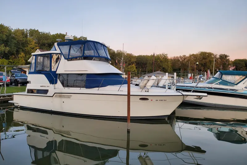 Slide: The Image of 1994 Carver 390 Cockpit Motor Yacht docked at marina, reflecting on calm water. - 42