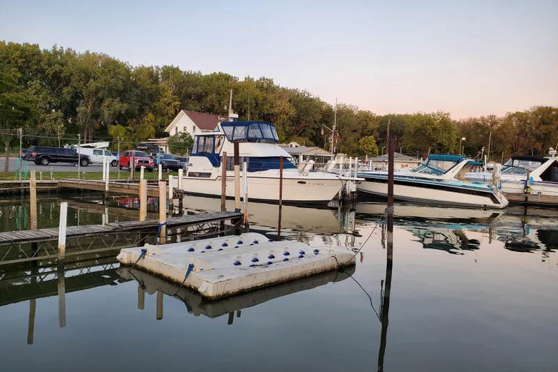 Slide: The Image of 1994 Carver 390 Cockpit Motor Yacht docked at a serene marina. - 5