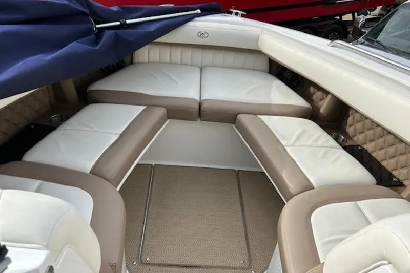 Slide: The Image of 2014 Cobalt 302 boat interior with beige and white cushioned seating. - 13