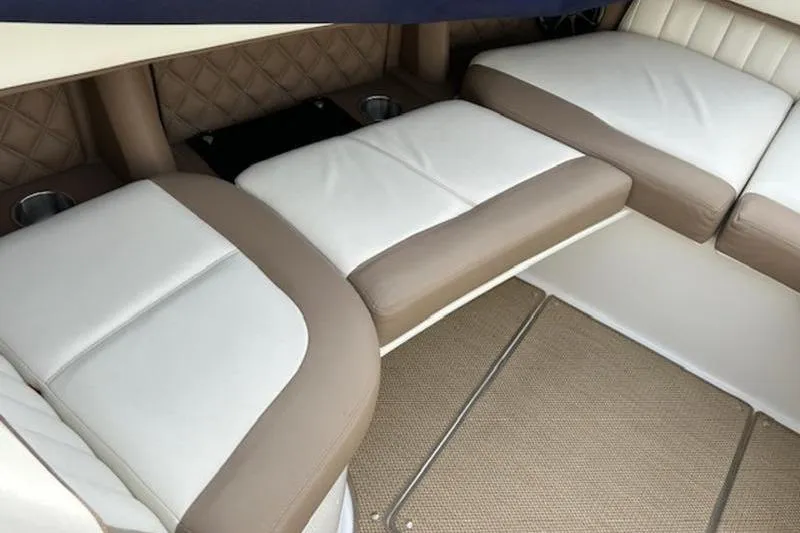 Slide: The Image of 2014 Cobalt 302 boat interior with beige and white cushioned seating. - 14