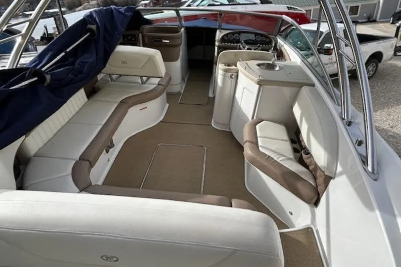 Slide: The Image of 2014 Cobalt 302 boat interior with beige seating and modern dashboard. - 4