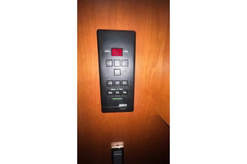 Slide: The Image of Control panel on 2001 Cruisers Yachts 3572 Express, mounted on wooden surface. - 18