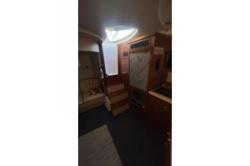 Slide: The Image of Interior of 2001 Cruisers Yachts 3572 Express, featuring seating and cabinetry. - 19