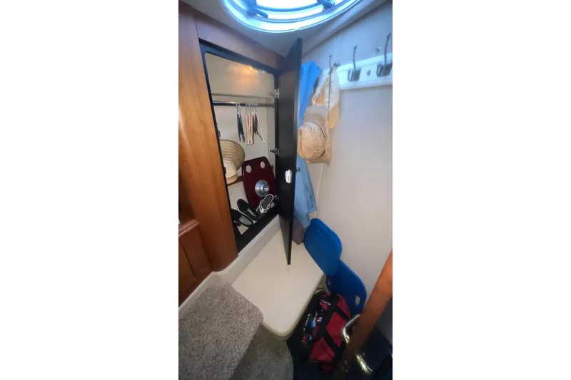 Slide: The Image of Interior of 2001 Cruisers Yachts 3572 Express showing storage area with hats and clothes. - 22