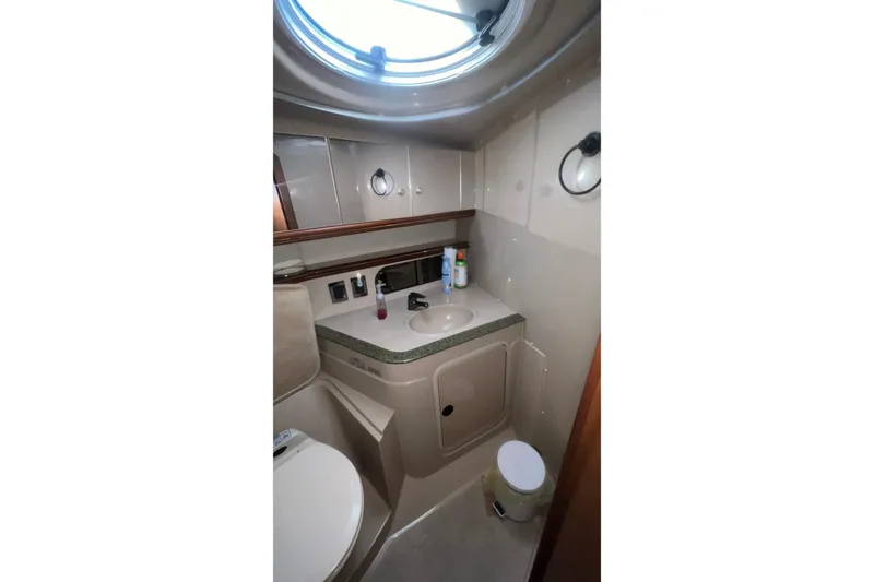 Slide: The Image of Bathroom interior of 2001 Cruisers Yachts 3572 Express with sink and porthole window. - 23